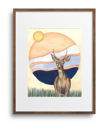 Framed artwork of a deer in a field with a sunset background