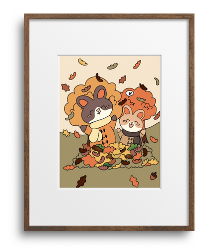 Framed artwork of two cartoon bunnies with autumn leaves on a beige background