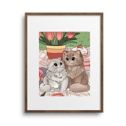 Framed artwork of two cats sitting together with flowers in the background on a white wall.